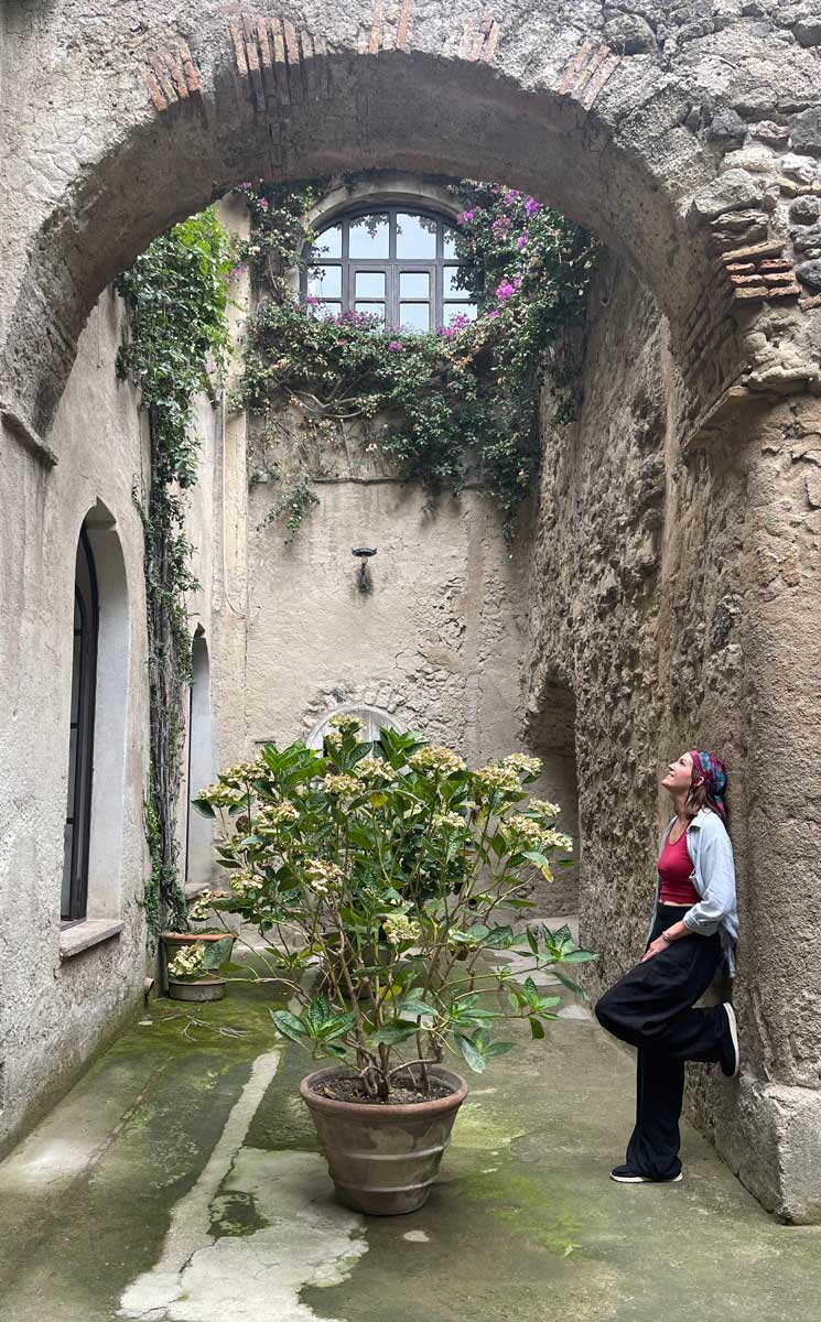 Stone archway with woman leaning against wall